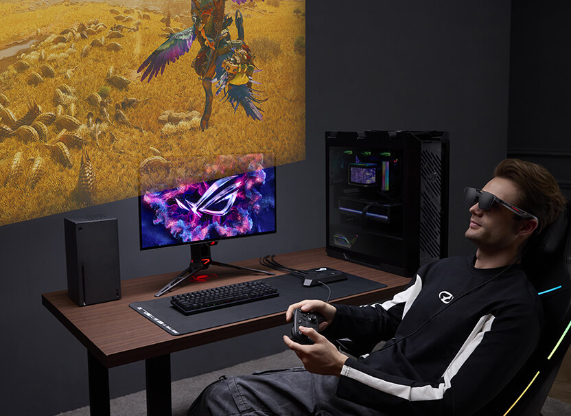 A Man using ROG R1 Gaming AR glasses to play Monster Hunter game on ROG Xbox Ally handheld and chill on sofa